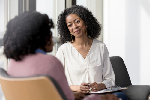 A senior female client at Harford Belair speaks with a staff counselor.