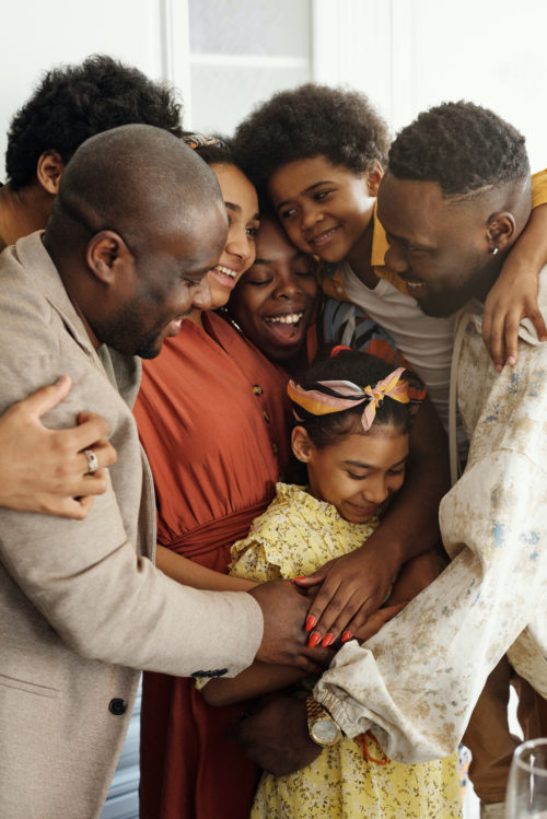 A family hugs one another in joy at Harford Belair.